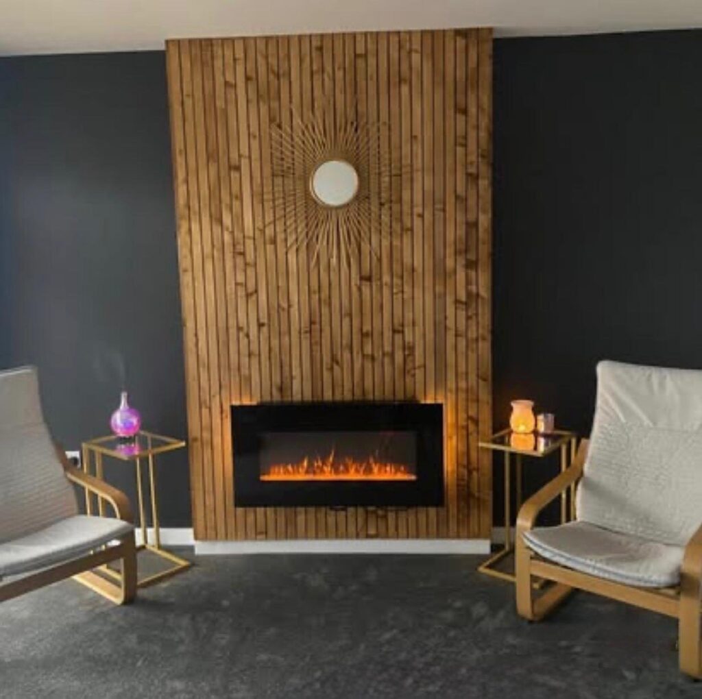Timber batten feature wall with built-in electric fireplace by Claymill Construction