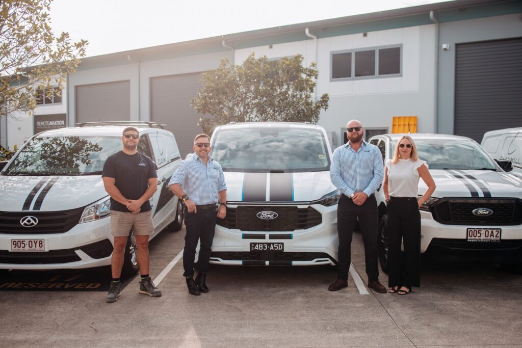 Claymill team members with the company fleet outside the workshop