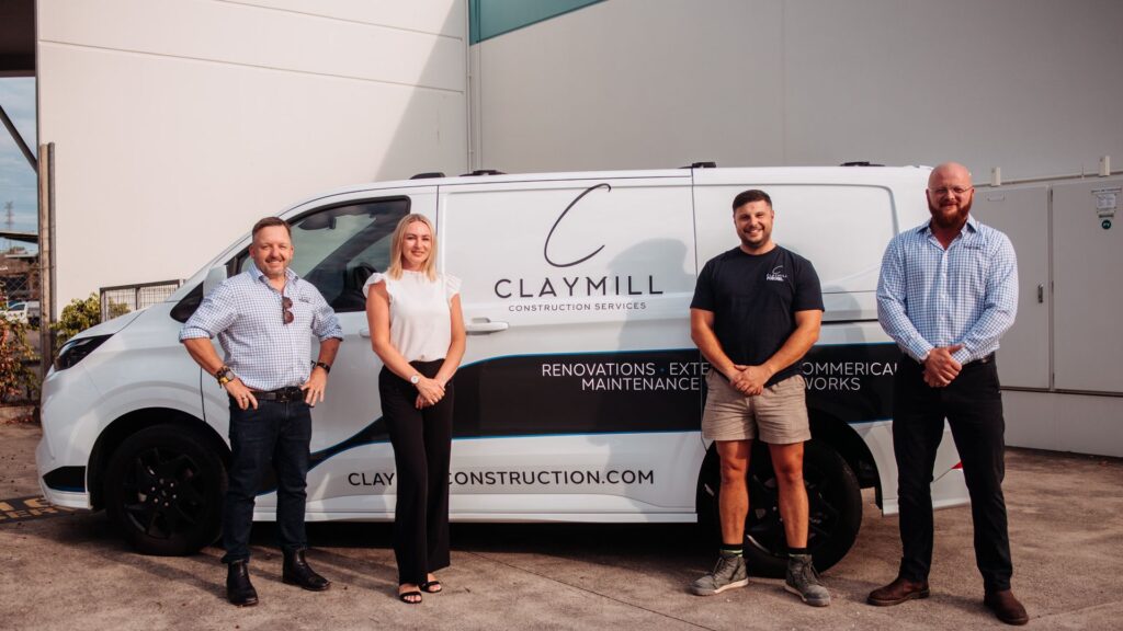 The Claymill Construction Services team standing beside a branded Claymill van